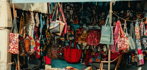 Colorful textile and fashion stalls in a Nairobi market, showcasing diverse African patterns and designs.